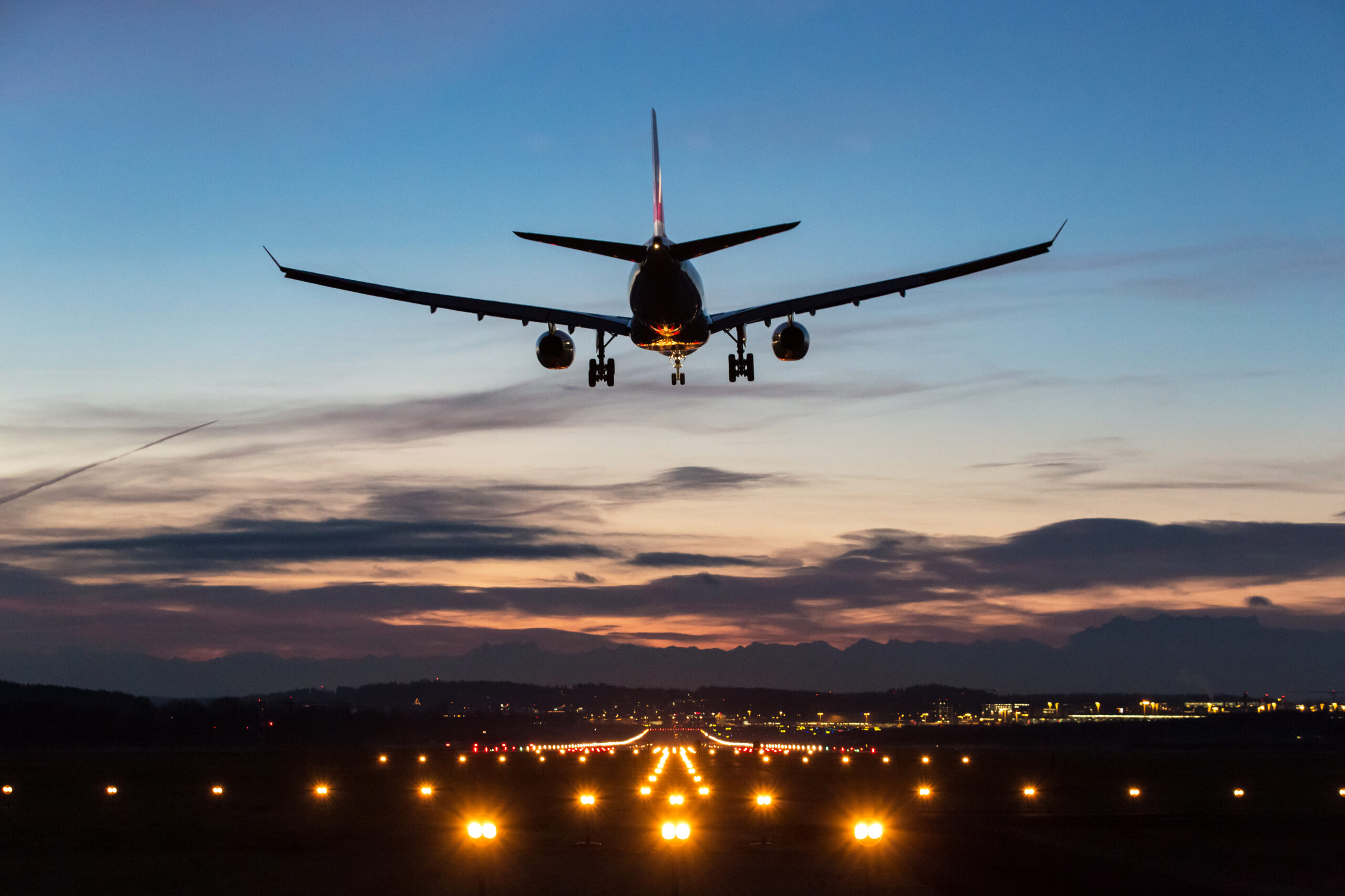 Photo of an airplane landing on a runway