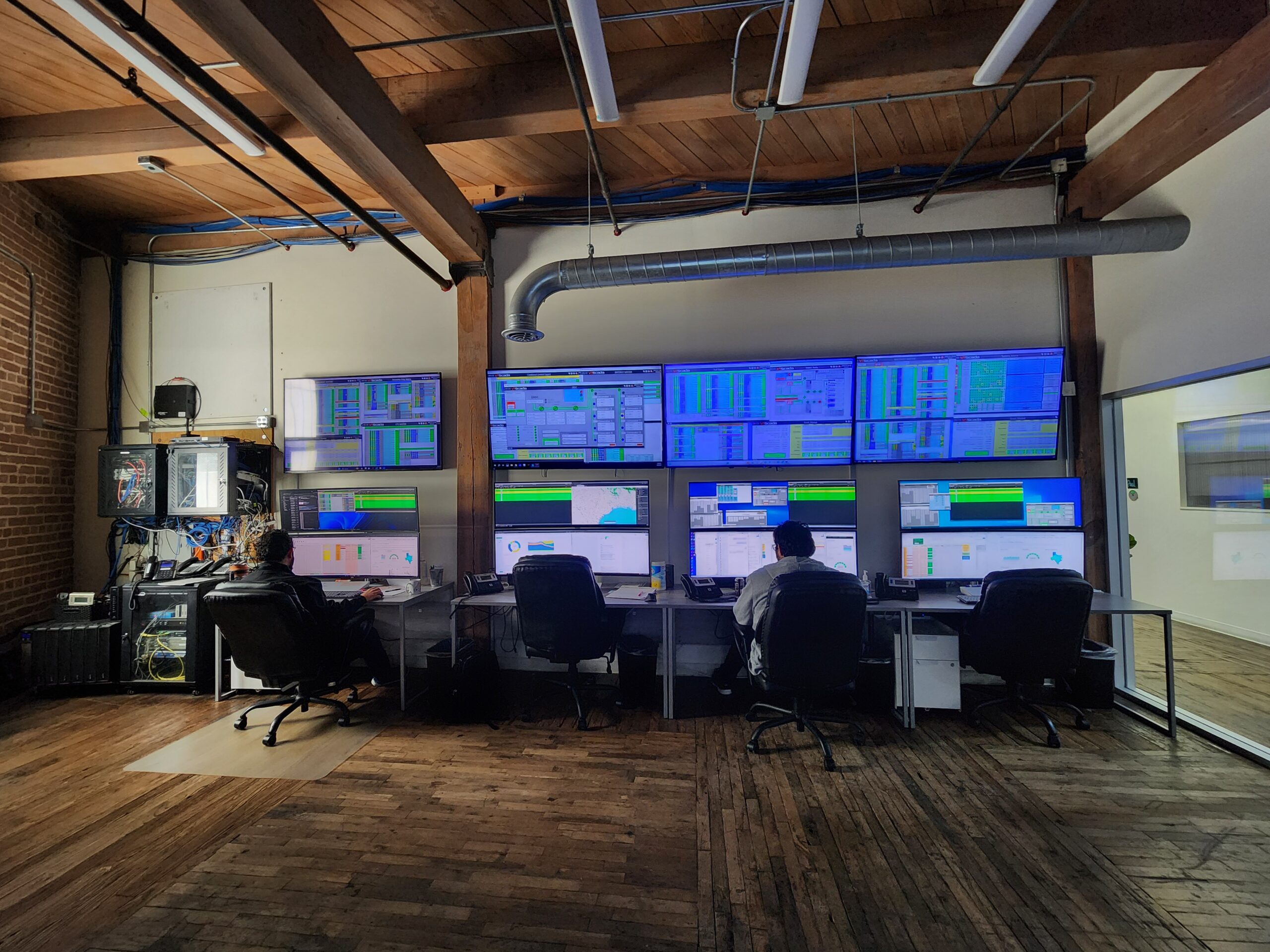 Four computer screens show energy information from across the state of Texas.