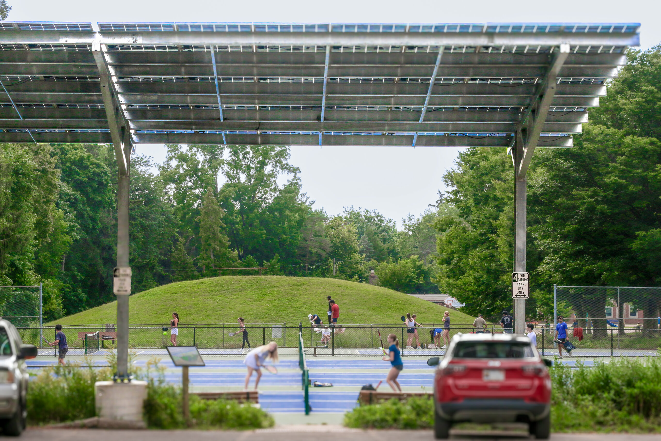 A solar panel array over a parking lot at Burns Park in Ann Arbor, Michigan in summertime.