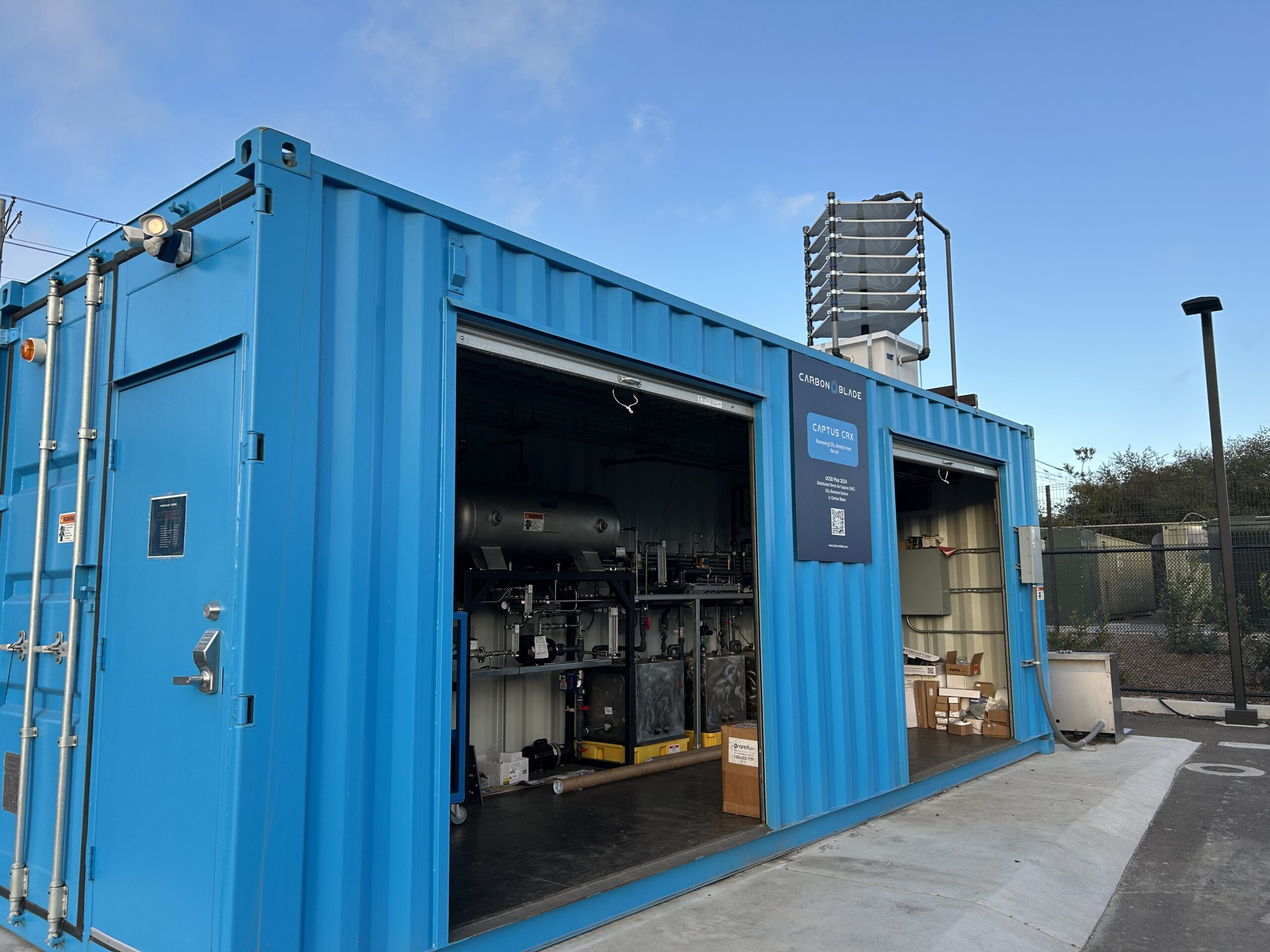 A blue container houses the modular carbon removal technology developed by San Diego-based startup Carbon Blade. The technology can be seen in the parking lot of the University of California-San Diego's Clean Energy Center.