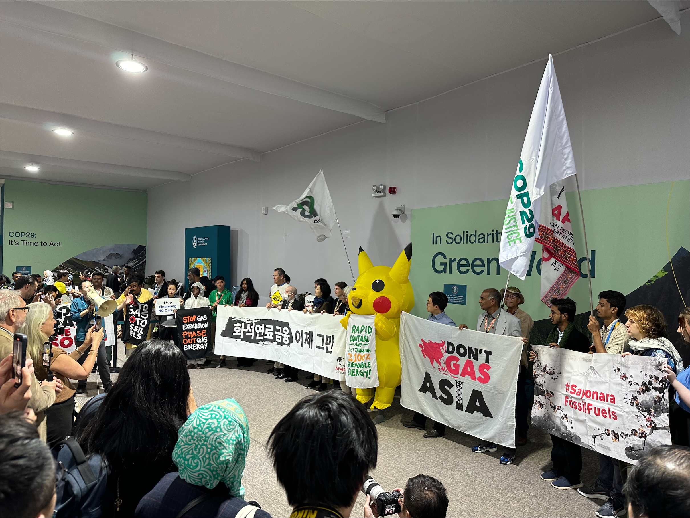 Photo of a protest happening indoors at COP29.