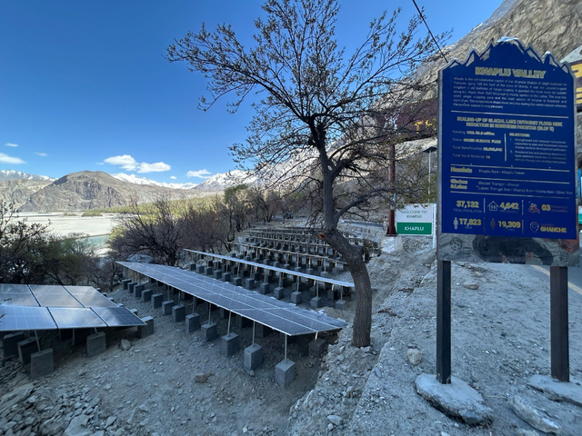 Visitors entering the Khaplu Valley are greeted by a sign providing a history of the ancient town of Khaplu. Behind the sign you can see an array of solar panels pumping water from the nearby Shyok River for the town's residents. Photo by Amena H. Saiyid