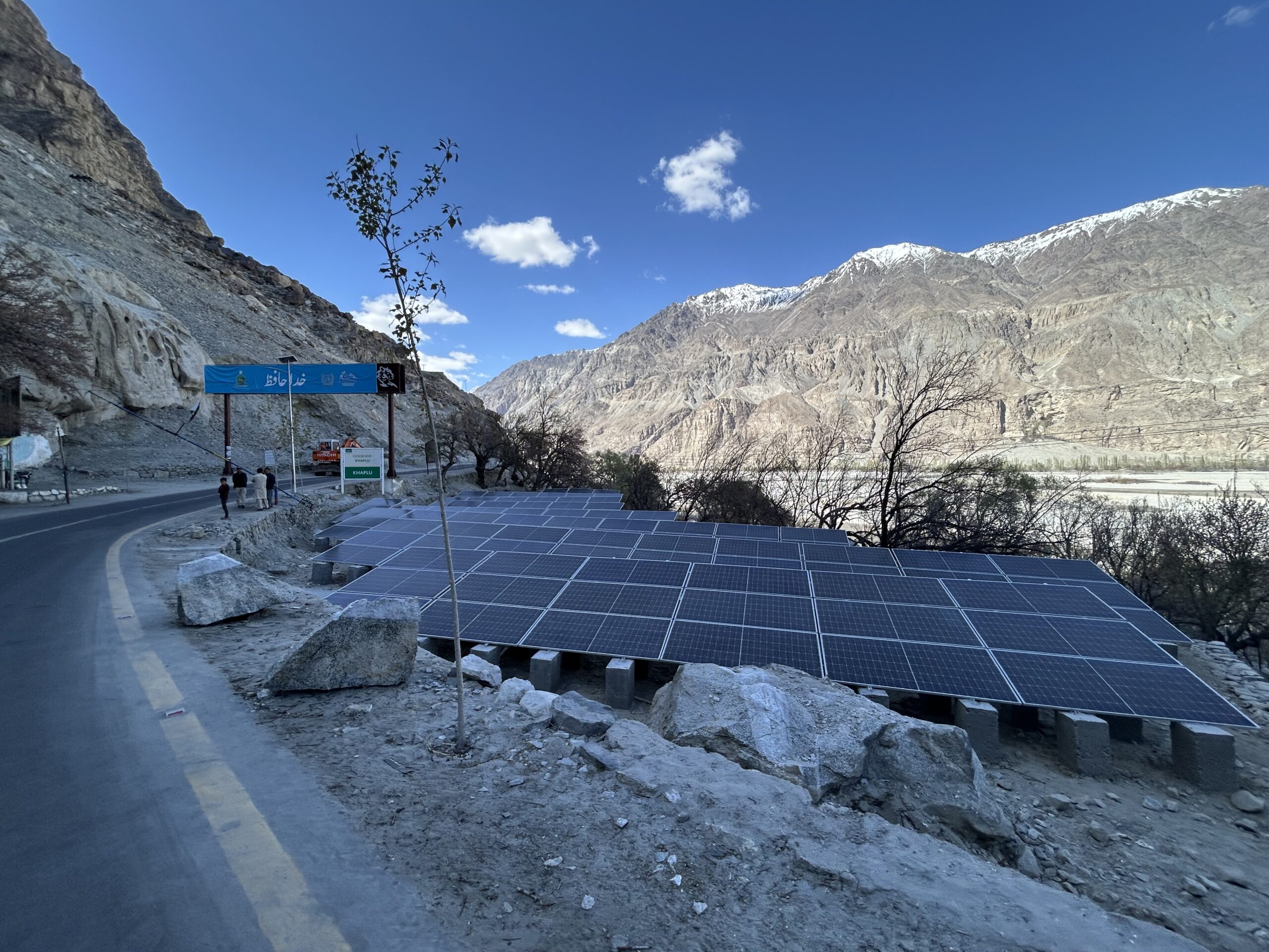 Descending rows of solar panels against the backdrop of the Karakoram Range. These panels pump water to supply the city of Khaplu's residents.